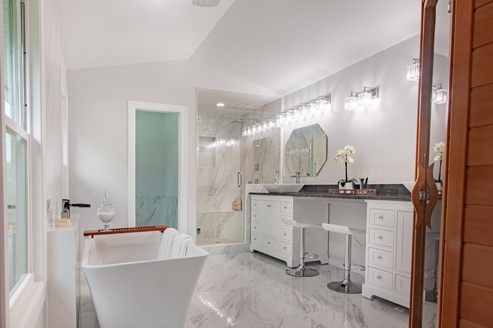 Primary bath with a freestanding tub and marble surround