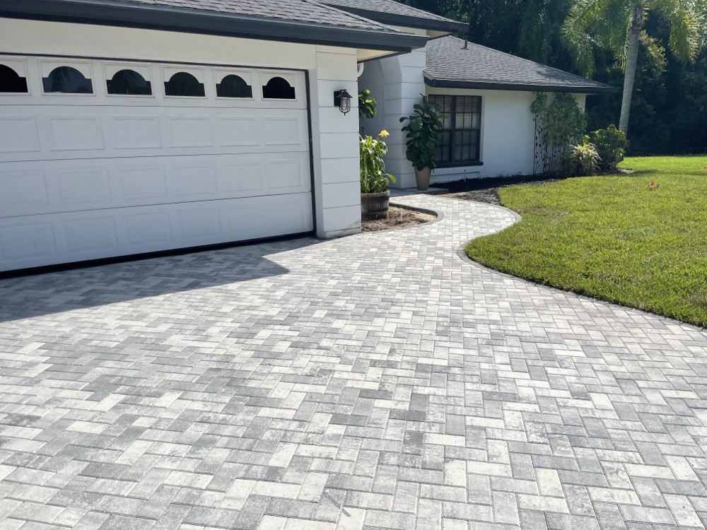 Completed new home with a curved paver drive