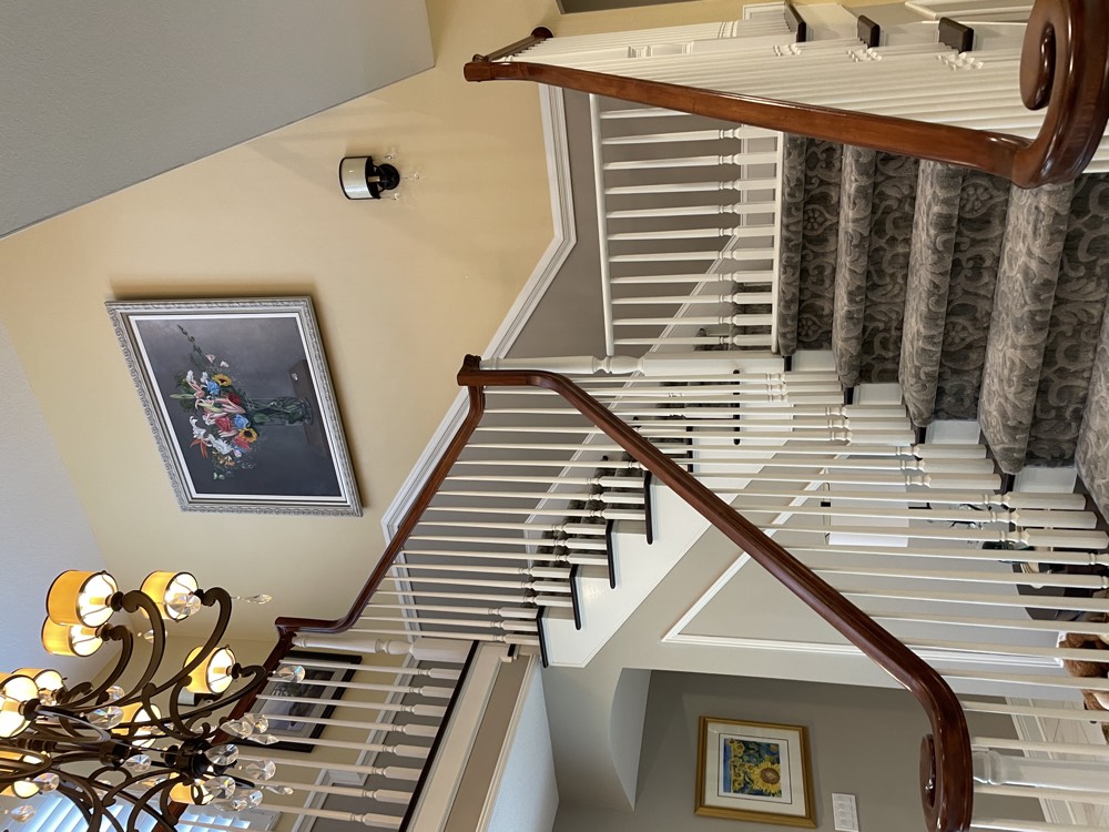 Two-story foyer with a curved staircase and chandelier