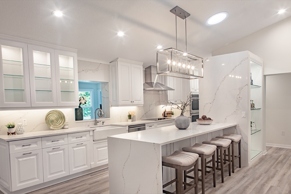 Renovated kitchen with a quartz waterfall island